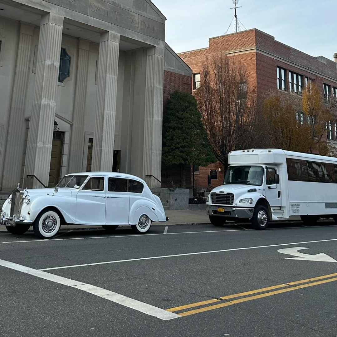 Camelot wedding cars parked outside a church