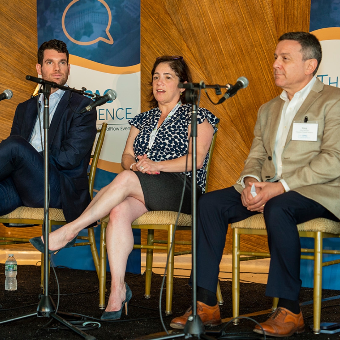 SPAC Conference speakers seated at microphones